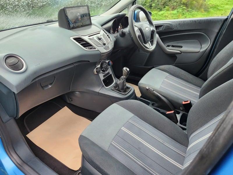 Interior of a blue Ford Fiesta car from the left forward