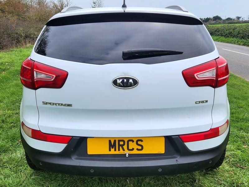 A white Kia Sportage viewed from the back
