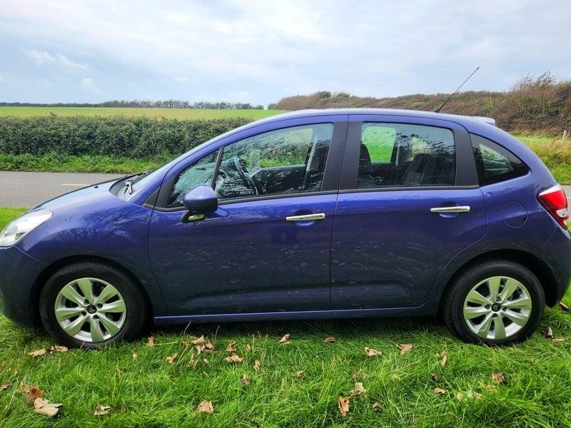 A blue Citroen C3 viewed from the left side