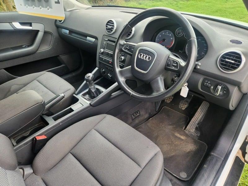 The front seats, steering wheel and control panels of an Audi A3