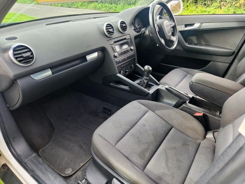 Front seats, steering wheel, and controls of an Audi A3 from the left side