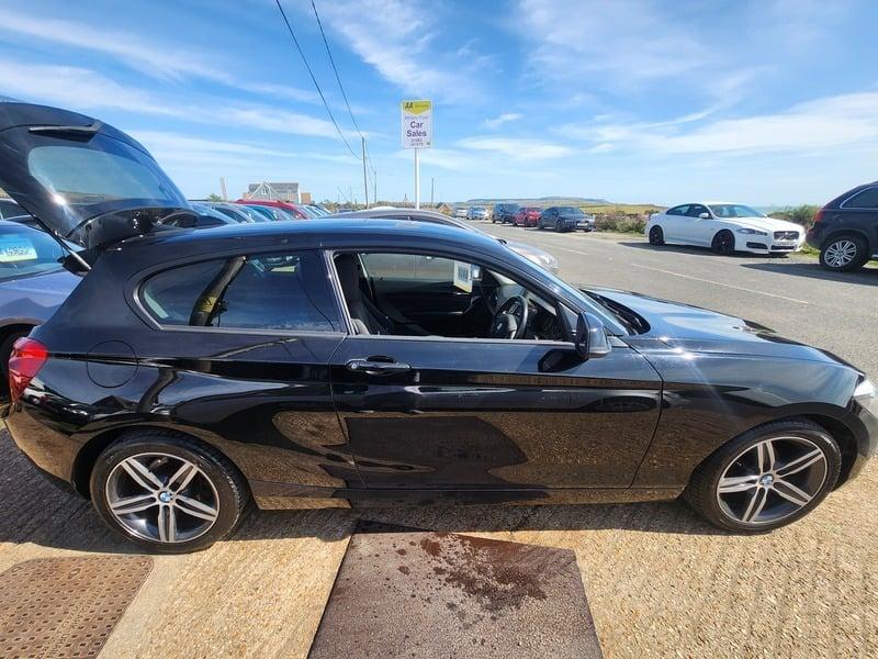 A jet black BMW 116i Sport viewed from the right side