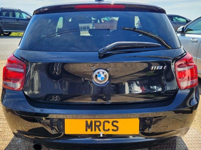 A jet black BMW 116i Sport viewed from the back