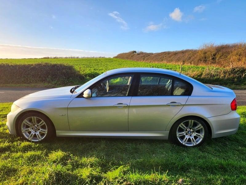 A silver BMW 3 Series 320d M Sport viewed from the left side
