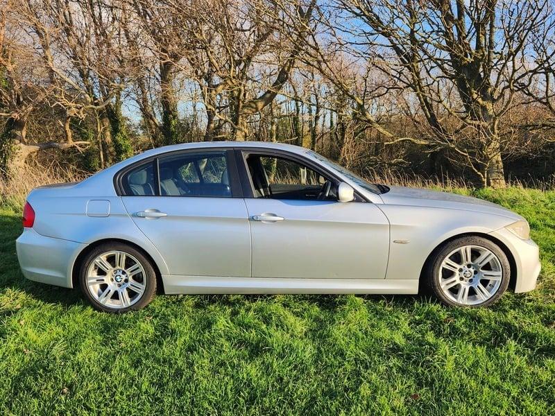 A silver BMW 3 Series 320d M Sport viewed from the right side