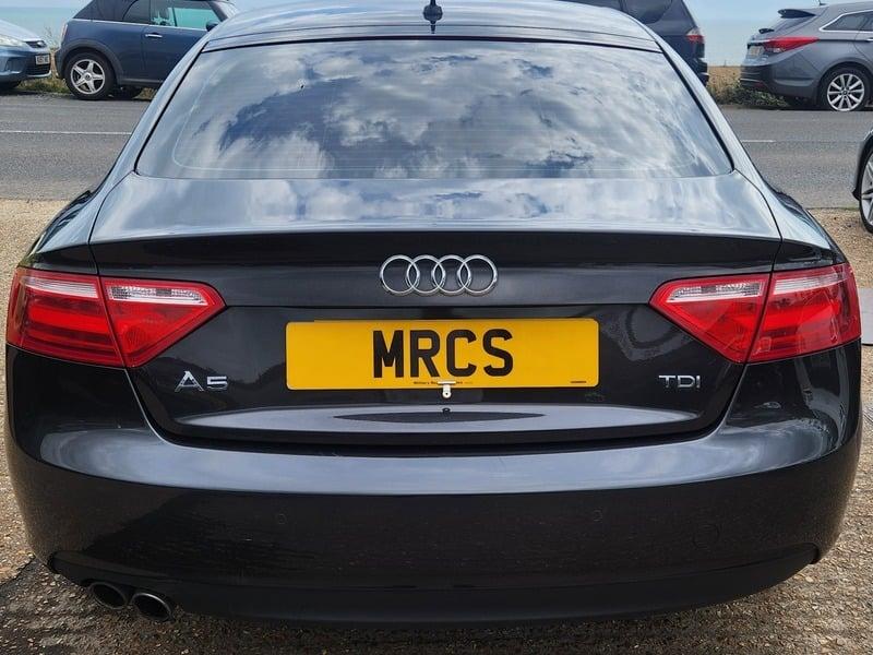 A monsoon grey Audi A5 Technik Sportback viewed from the back