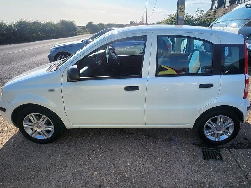 A white Fiat Panda Active viewed from the left side