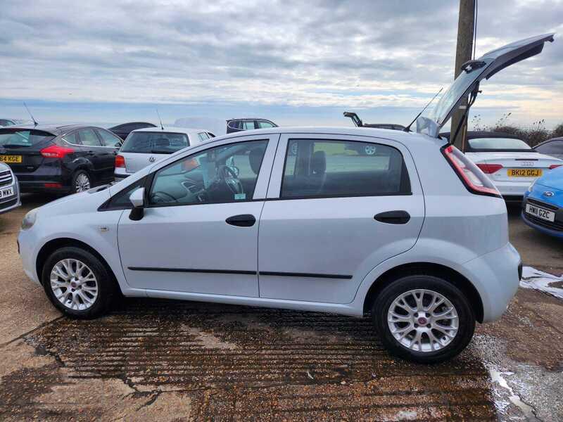 A white Fiat Punto 1.4 EVO viewed from the left side