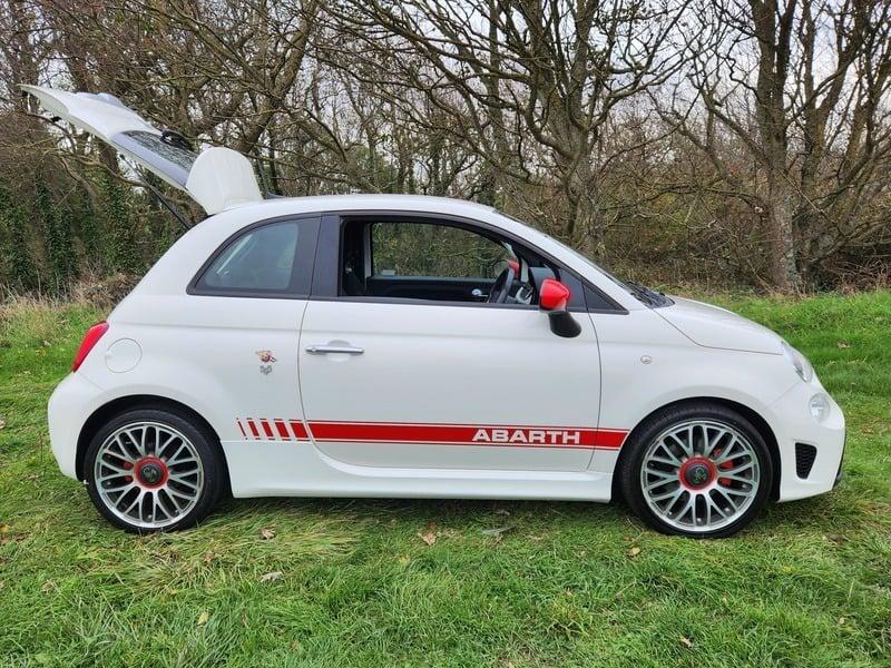 A white Fiat Abarth viewed from the right side
