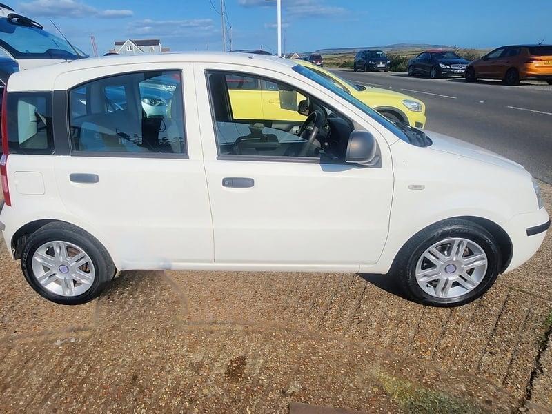 A white Fiat Panda Active viewed from the right side