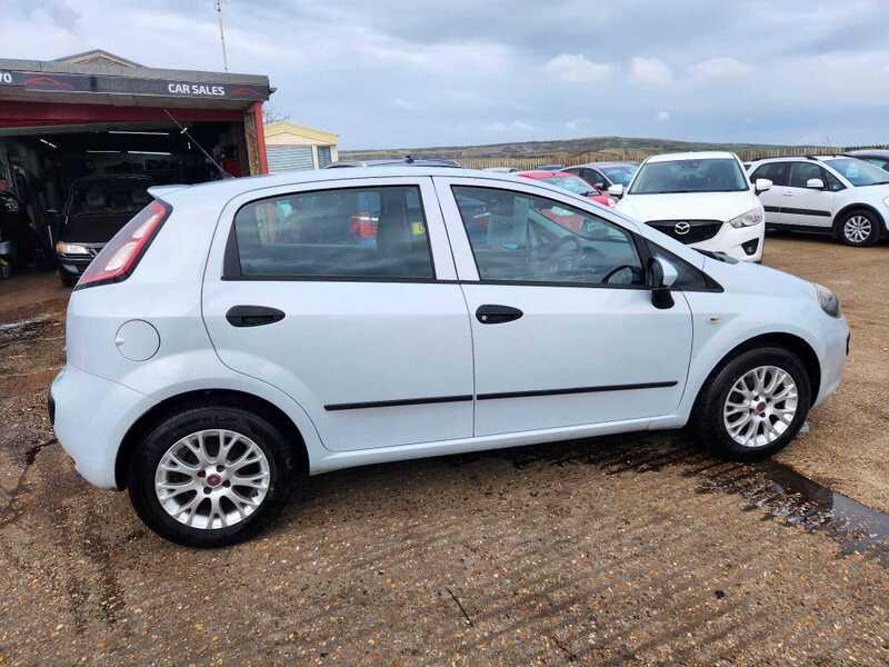 A white Fiat Punto 1.4 EVO viewed from the right side