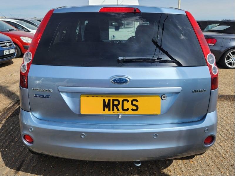 A blue Ford Fiesta 1.6 Ghia viewed from the back