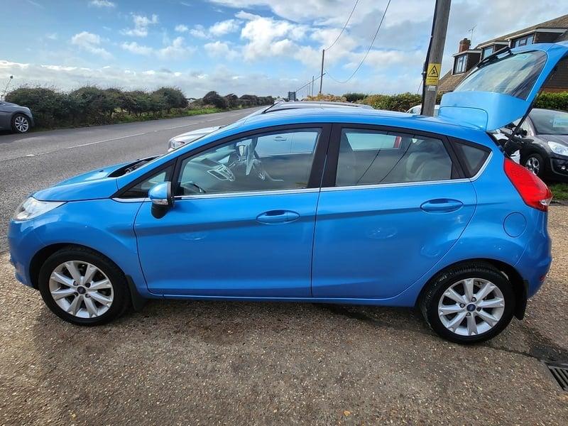 A blue Ford Fiesta 1.4 Zetec viewed from the left side