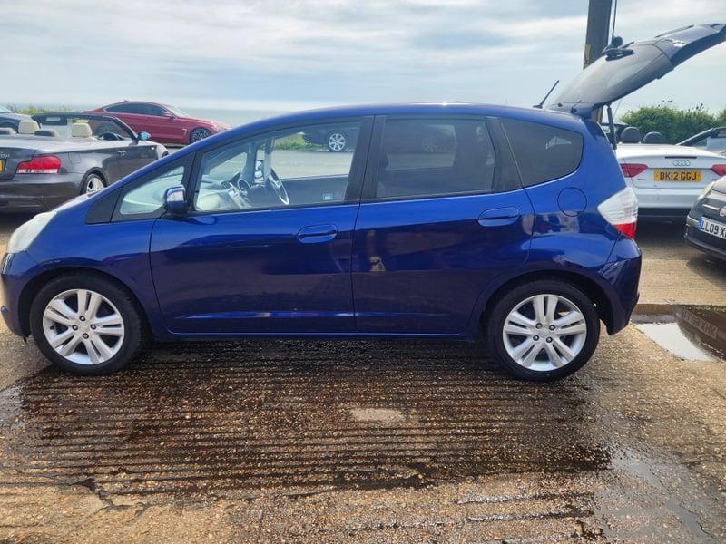 A blue Honda Jazz viewed from the outside left