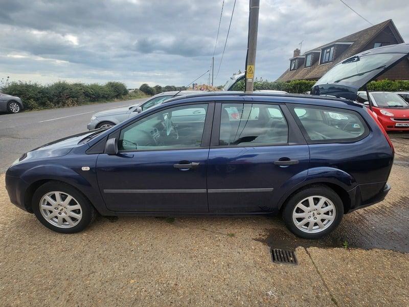 A blue Ford Focus LX Estate viewed from the left side
