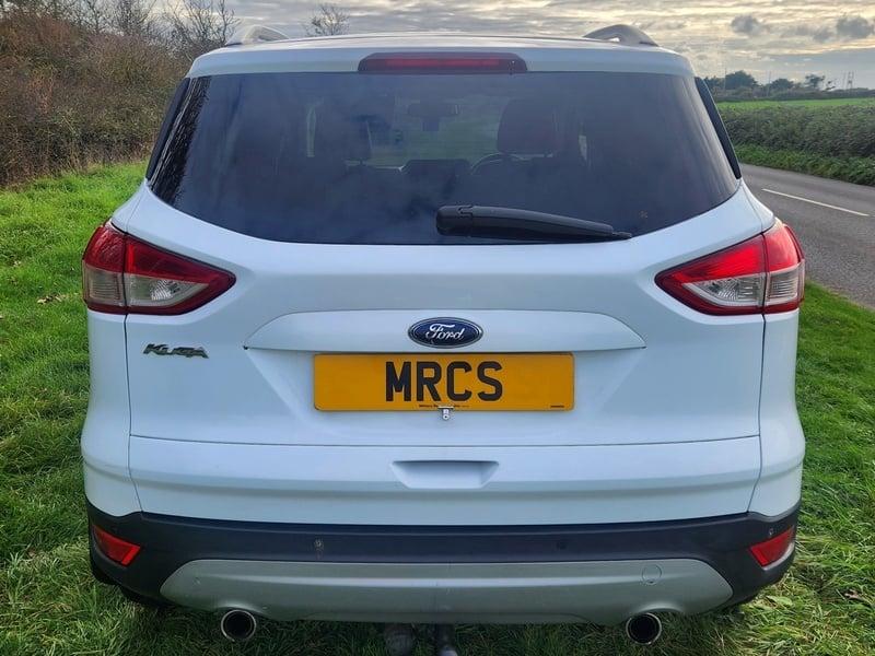 A white Ford Kuga viewed from the outside back