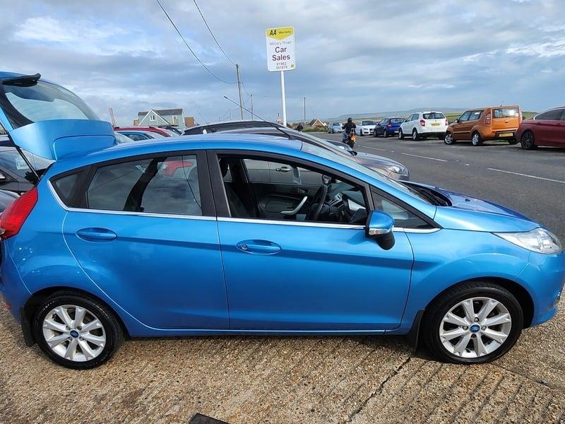 A blue Ford Fiesta 1.4 Zetec viewed from the right side