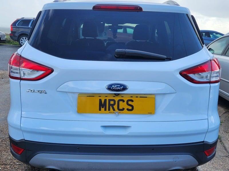 A white Ford Kuga viewed from the outside back