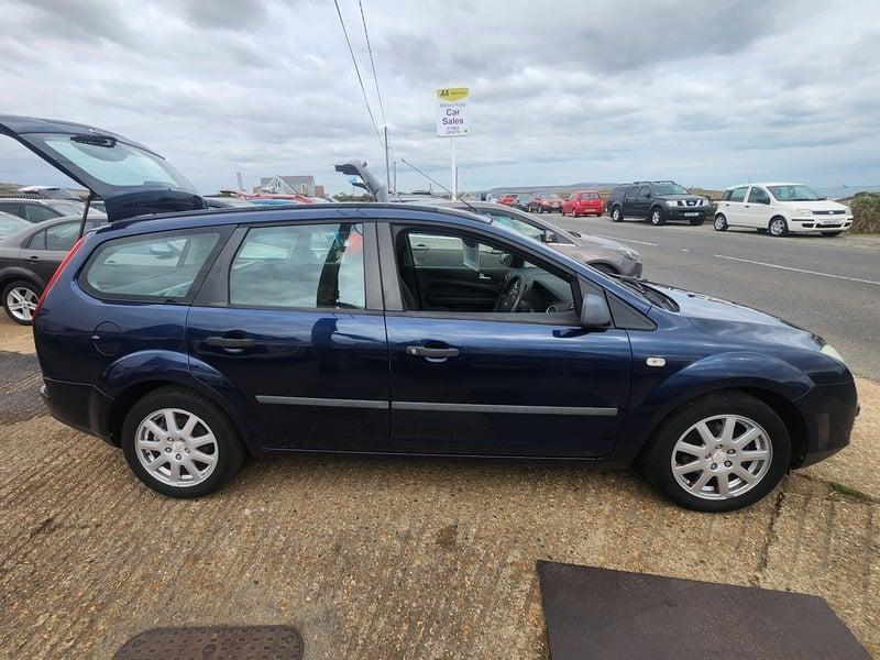 A blue Ford Focus LX Estate viewed from the right side