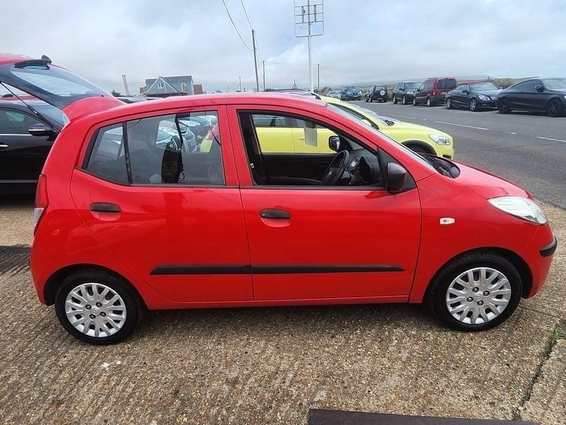 A red Hyundai I-10 Classic viewed from the outside right