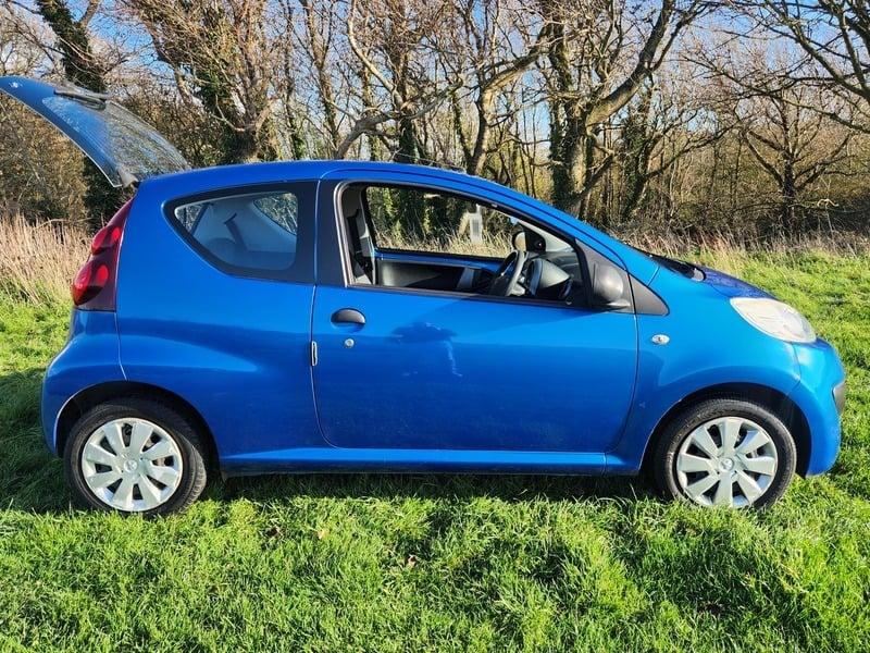 An Aegean Blue Peugeot 107 viewed from the outside right