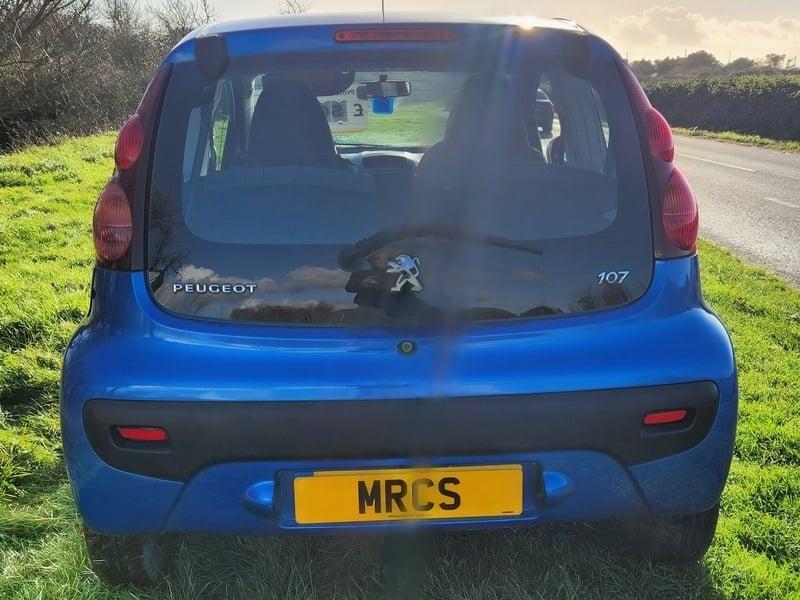 An Aegean Blue Peugeot 107 viewed from the outside back