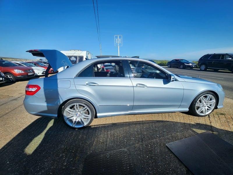 A silver Mercedes E-Class viewed from the outside right