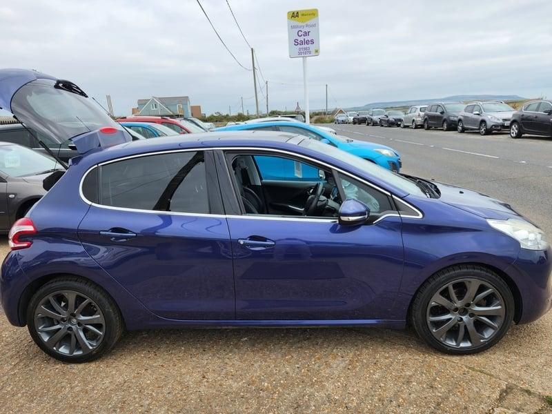 A Vertigo Blue Peugeot 208 viewed from the outside right