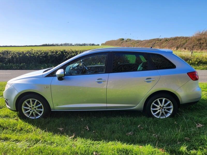 A silver Seat Ibiza viewed from the outside left