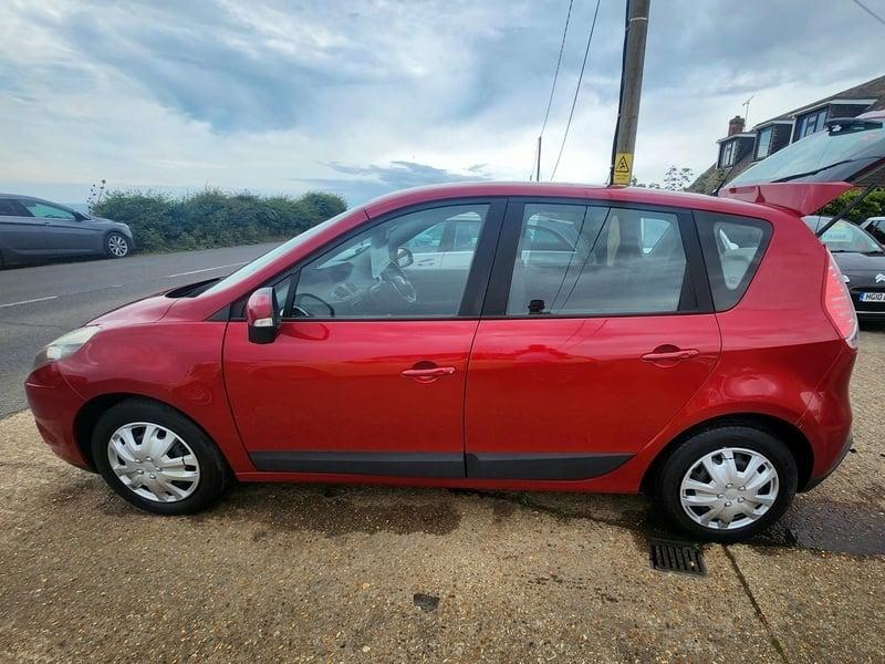 A red Renault Scenic viewed from the left side