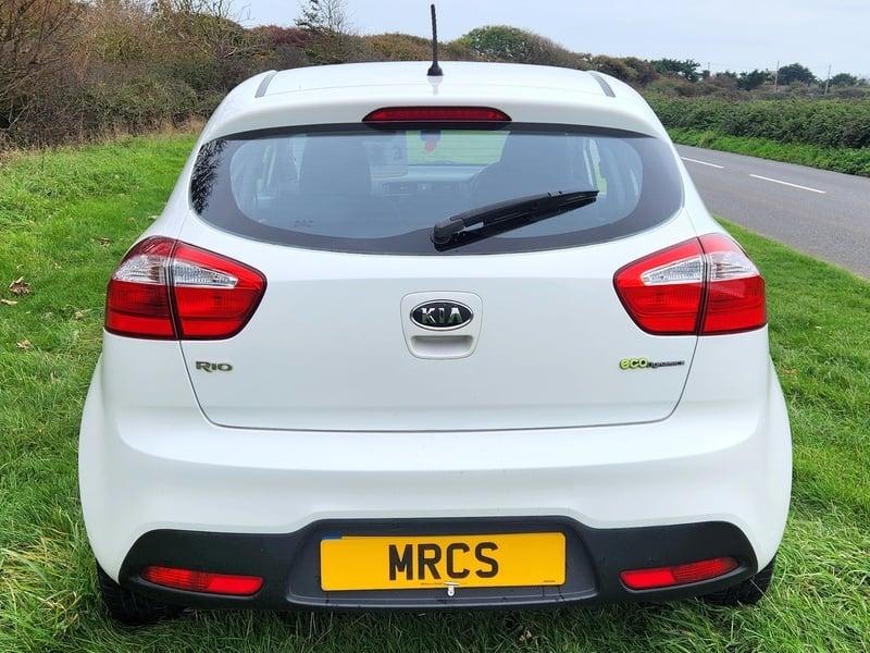 A white KIA Rio ECODynamics viewed from the outside back