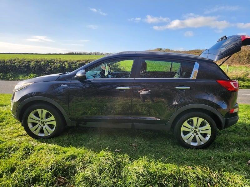 A black KIA Sportage viewed from the outside left