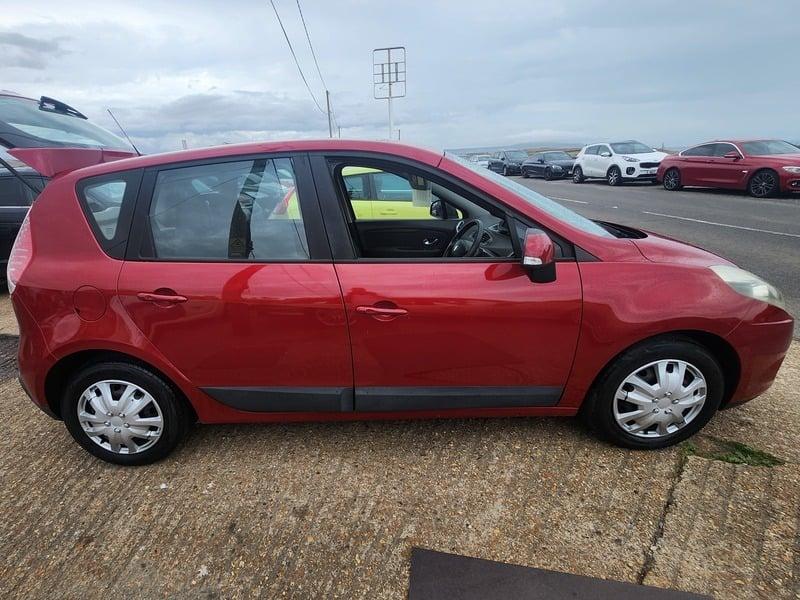 A red Renault Scenic viewed from the right side
