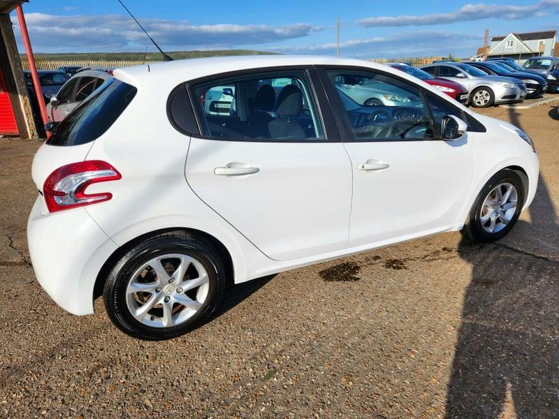 A white Peugeot 208 Active viewed from the outside right rear corner
