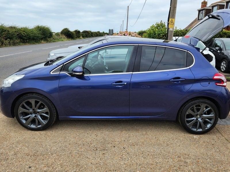 A Vertigo Blue Peugeot 208 viewed from the outside left