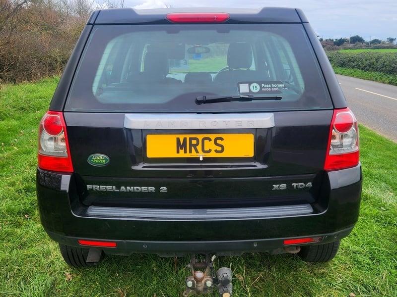 A black Land Rover FreeLander viewed from the outside back