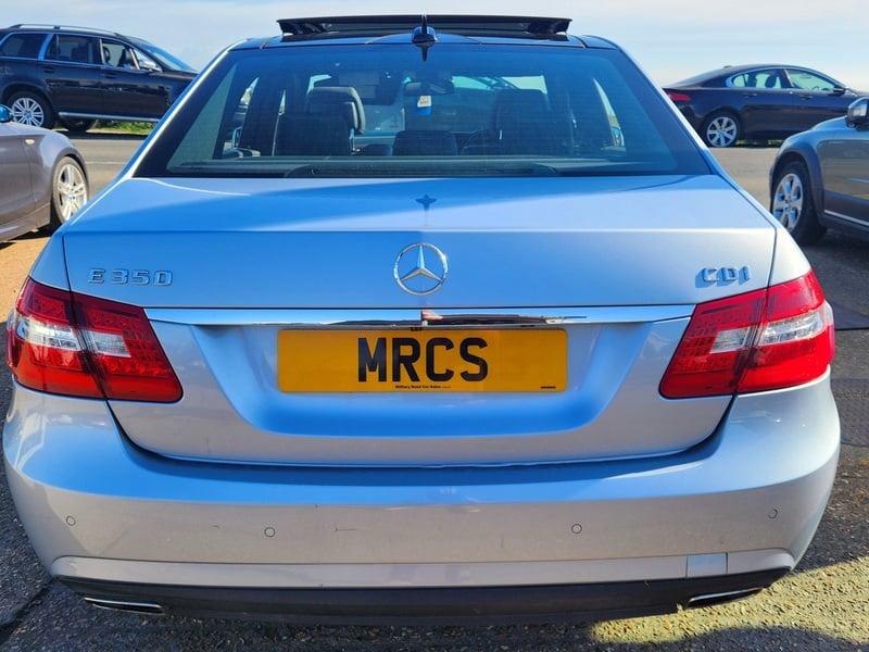 A silver Mercedes E-Class viewed from the outside back