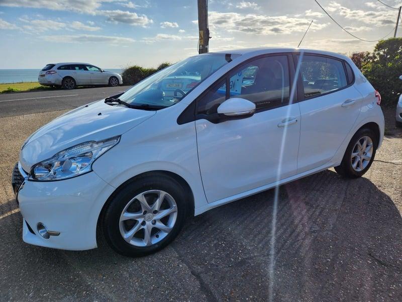 A white Peugeot 208 Active viewed from the outside left corner