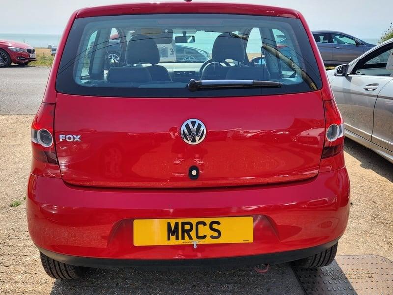 A red Volkswagen Fox viewed from behind