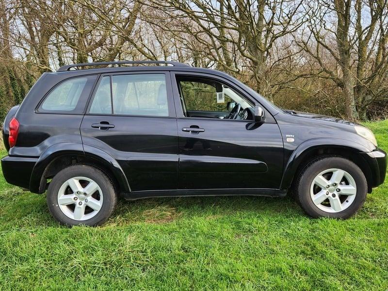 A black Toyota RAV-4 viewed from the right side