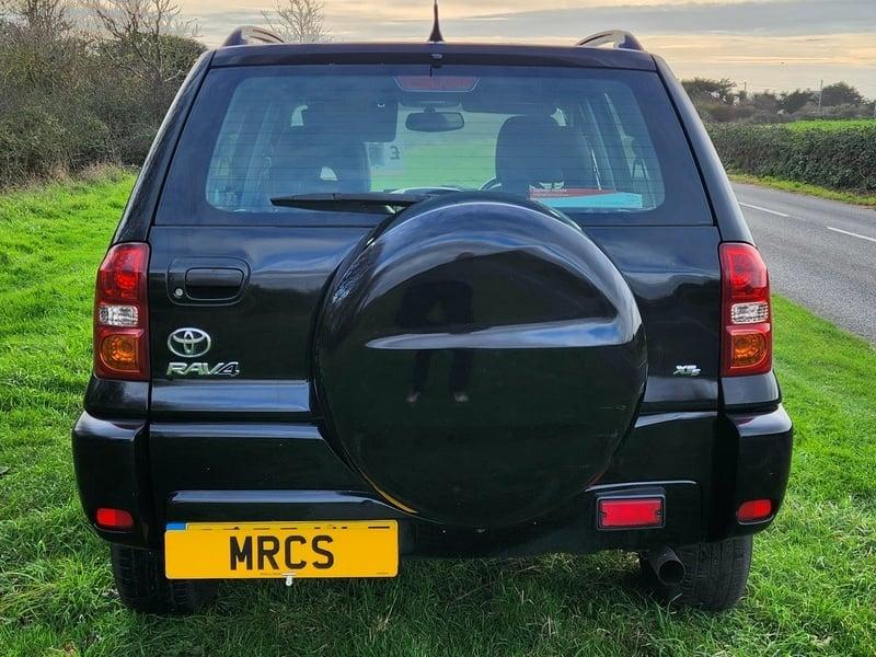 A black Toyota RAV-4 viewed from behind