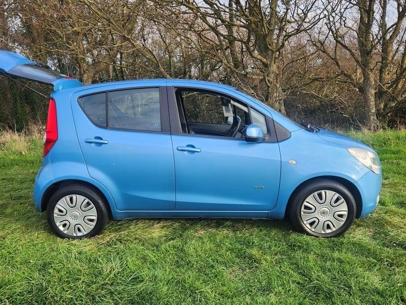 A blue Vauxhall Agila viewed from the right side