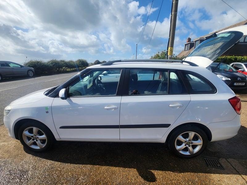 A white Skoda Fabia Greenline TDI CR Estate viewed from the outside left