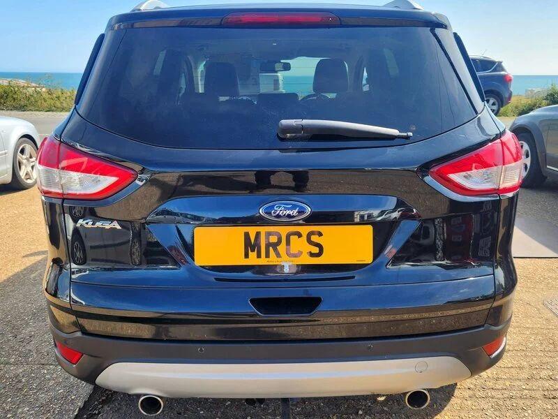 A black Ford Kuga viewed from behind