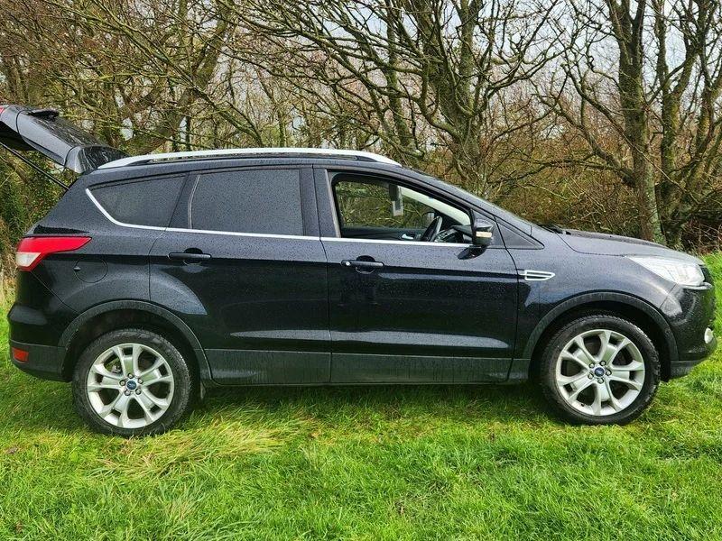 A black Ford Kuga viewed from the right side