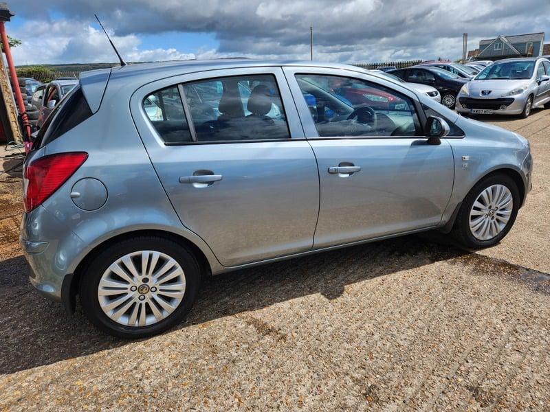 A silver Vauxhall Corsa Excite viewed from the right outside