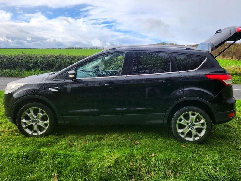 A black Ford Kuga viewed from the left side