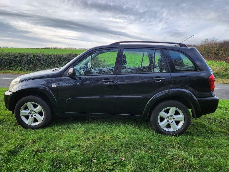 A black Toyota RAV-4 viewed from the left side