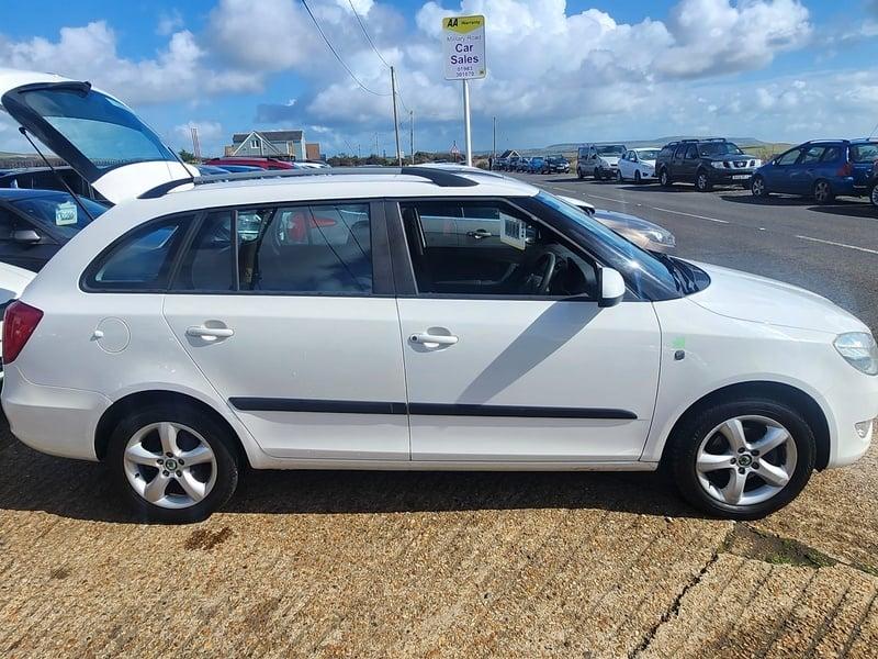 A white Skoda Fabia Greenline TDI CR Estate viewed from the outside right