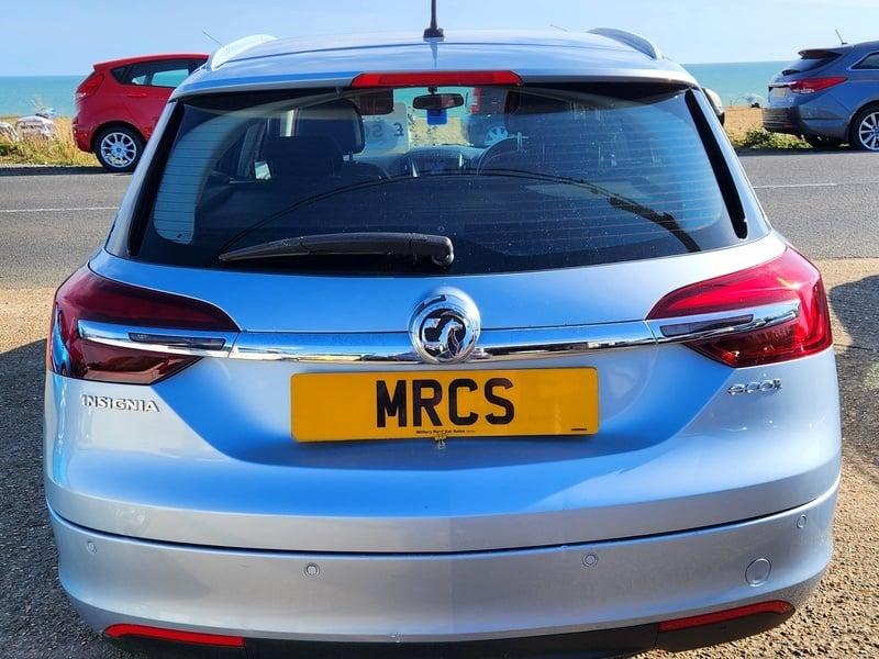 A silver Vauxhall Insignia Estate viewed from behind